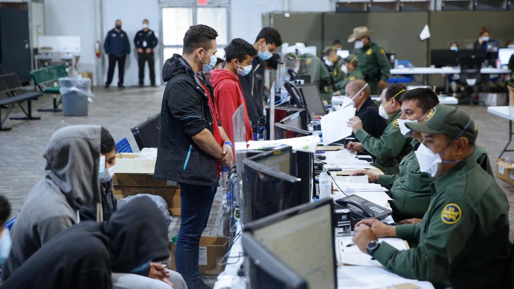 Migrants are processed at the intake area of the Donna Department of Homeland Security holding facility, the main detention center for unaccompanied children in the Rio Grande Valley, in Donna, Texas. (AP Photo/Dario Lopez-Mills,Pool)
