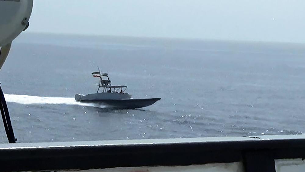 A boat of Iran&#039;s Islamic Revolutionary Guard Corps Navy (IRGCN) operates in close proximity to patrol coastal ship USS Sirocco (PC 6) and expeditionary fast transport USNS Choctaw County (T-EPF 2) in the Strait of Hormuz, June 20, 2022 (U.S. Navy via AP)