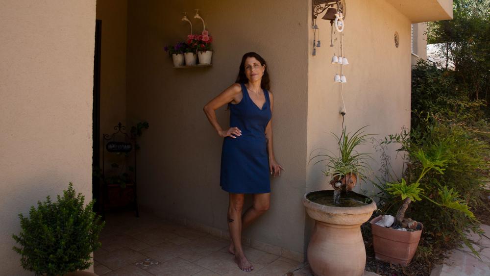 Idit Harel Segal, who donated a kidney to a Palestinian child from the Gaza Strip, poses for a portrait in her home in Eshhar, northern Israel, Tuesday, July 13, 2021. (AP Photo/Maya Alleruzzo).