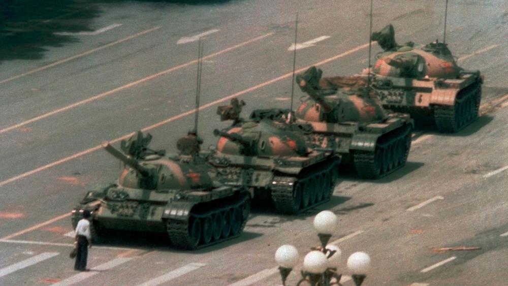 In this June 5, 1989 file photo, a Chinese man stands alone to block a line of tanks heading east on Beijing&#039;s Changan Blvd. in Tiananmen Square. (AP Photo/Jeff Widener, File) 