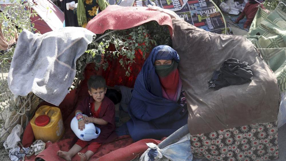 Displaced Afghans from northern provinces take refuge in a public park Kabul, Afghanistan, Friday, Aug. 13, 2021. (AP Photo/Rahmat Gul)