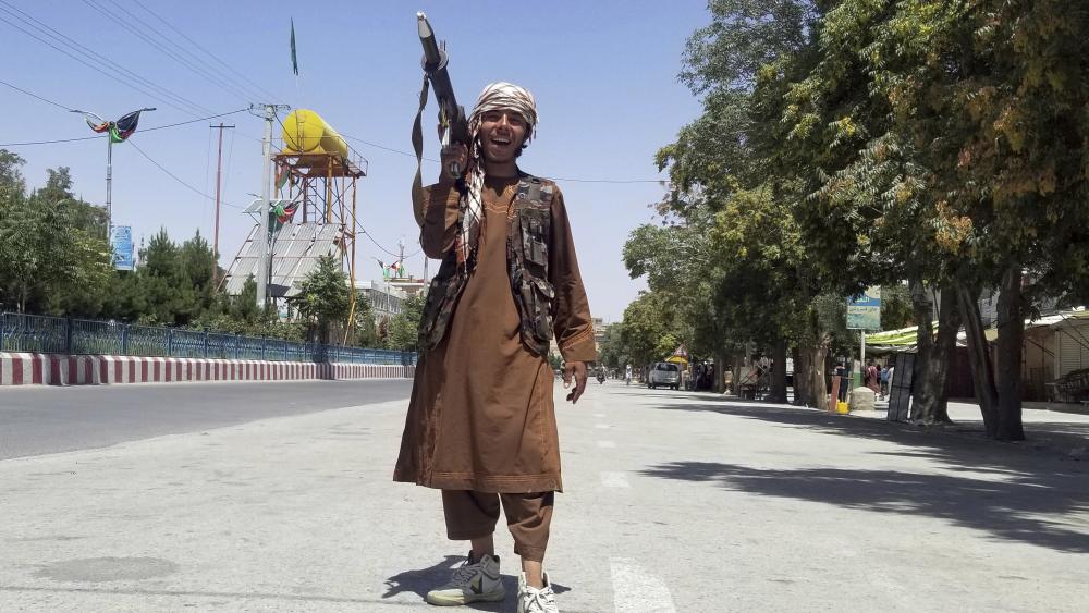 A Taliban fighter poses for a photo as he patrols inside the city of Ghazni, southwest of Kabul, Afghanistan, Thursday, Aug. 12, 2021