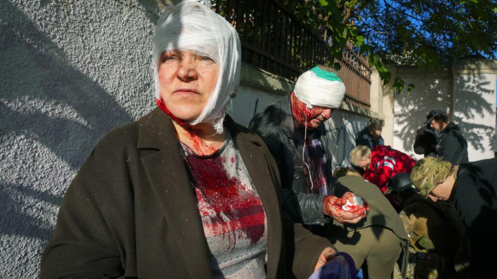 People receive medical treatment at the scene of Russian shelling, in Kyiv, Ukraine, Monday, Oct. 10, 2022  (AP Photo/Efrem Lukatsky )