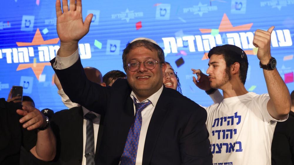 Israeli lawmaker Itamar Ben-Gvir, waves to his supporters after the first exit poll results in Jerusalem, Wednesday, Nov. 2, 2022. (AP Photo/Oren Ziv)