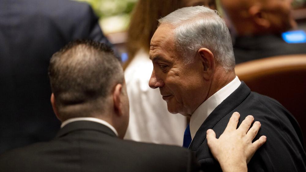 Israel&#039;s incoming Prime Minister Benjamin Netanyahu speaks with a colleague at the swearing-in ceremony for Israel&#039;s parliament, at the Knesset, in Jerusalem, Tuesday, Nov. 15, 2022. (AP Photo/ Maya Alleruzzo, Pool)