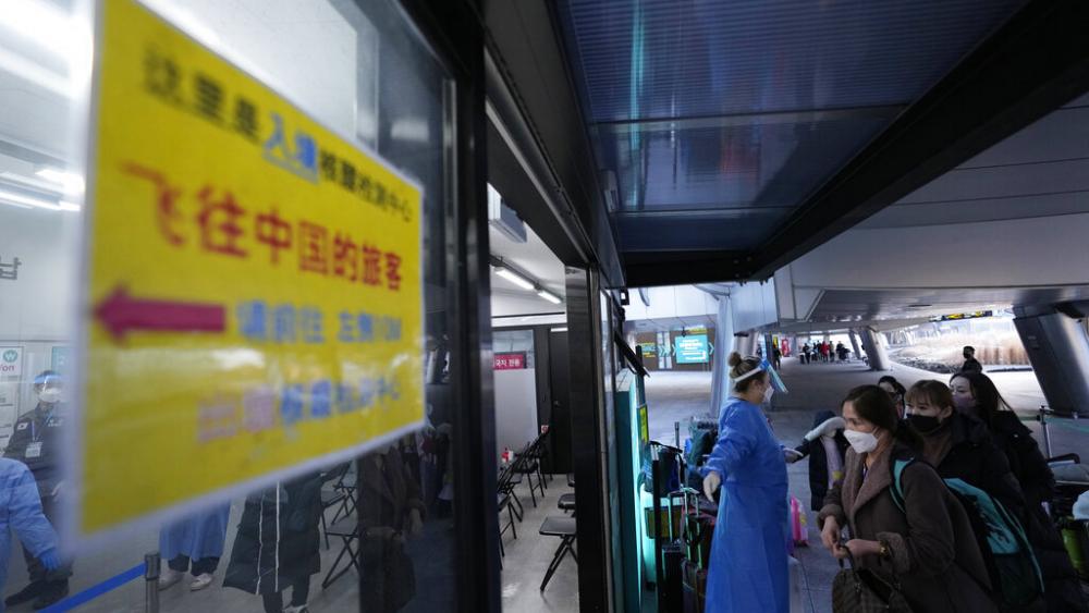 Passengers arriving from China enter a COVID-19 testing center in Seoul. Tuesday, Jan. 10, 2023. (AP Photo/Ahn Young-joon)
