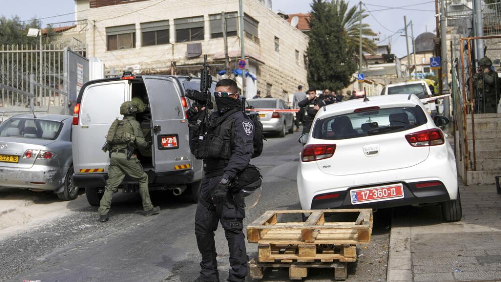 An Israeli policeman secures a shooting attack site in east Jerusalem, Saturday, Jan. 28, 2023. A Palestinian gunman opened fire in east Jerusalem on Saturday, wounding at least two people.  (AP Photo/Mahmoud Illean)