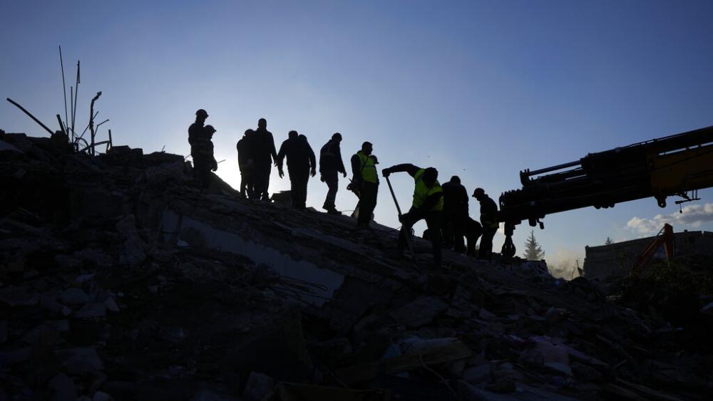 Rescue teams search for people in the rubble of destroyed buildings in Antakya, southern Turkey, Wednesday, Feb. 8, 2023. (AP Photo/Khalil Hamra)