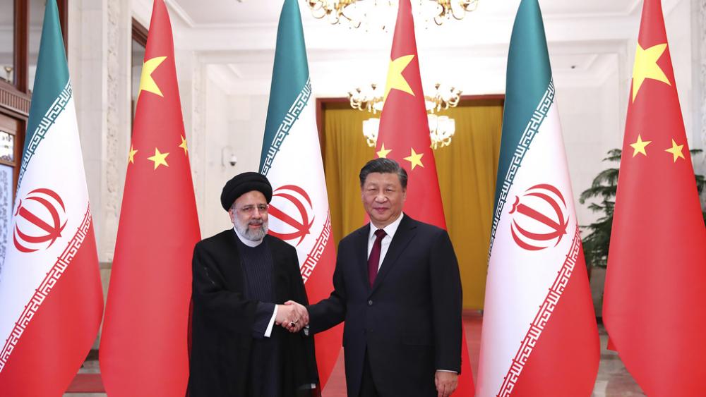 President Ebrahim Raisi, left, shakes hands with his Chinese counterpart Xi Jinping in an official welcoming ceremony in Beijing, Tuesday, Feb. 14, 2023. (Iranian Presidency Office via AP, File)