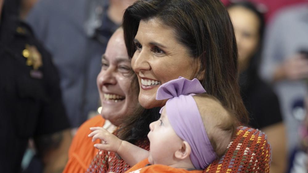 Republican presidential contender Nikki Haley, center, smiles with a woman and a baby after speaking at a campaign rally on Thursday, May 4, 2023, in Greer, S.C. (AP Photo/Meg Kinnard)