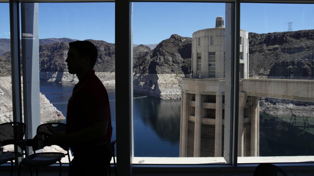 People attend a news conference at Hoover Dam, Nevada. Arizona. California and Nevada on Monday, May 22, proposed a deal to significantly cut their water use from the drought-stricken Colorado River over the next 3 years.(AP Photo/John Locher, File) 