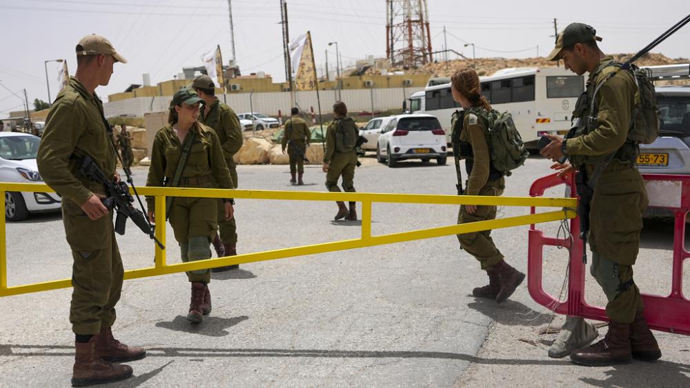Israeli soldiers secure a gate leading to a military base following a deadly shootout in southern Israel along the Egyptian border, Saturday, June 3, 2023. (AP Photo/Tsafrir Abayov)