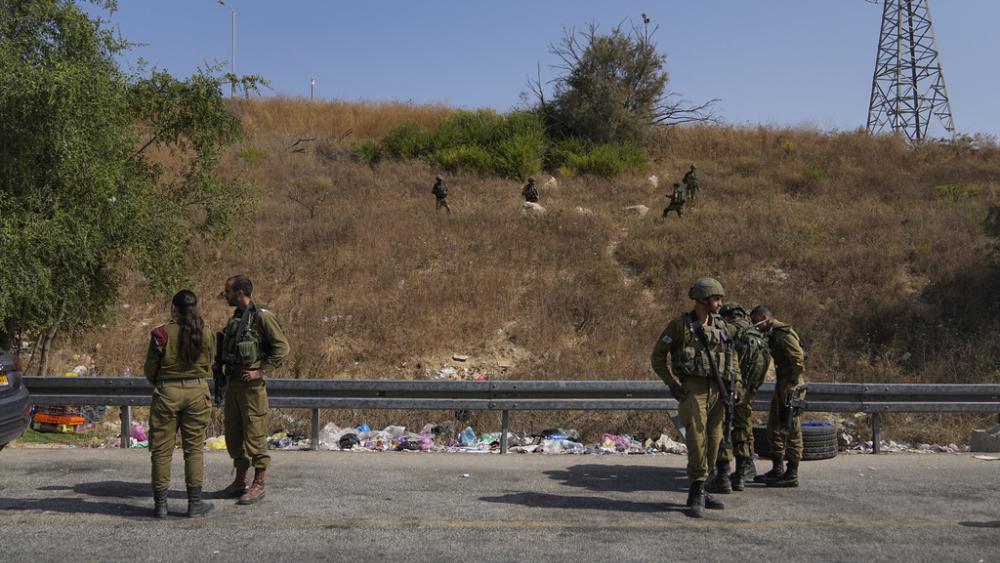 Israeli security forces inspect the scene of a Palestinian ramming attack near West Bank Maccabim checkpoint, Thursday, Aug. 31, 2023. (AP Photo/Ohad Zwigenberg)