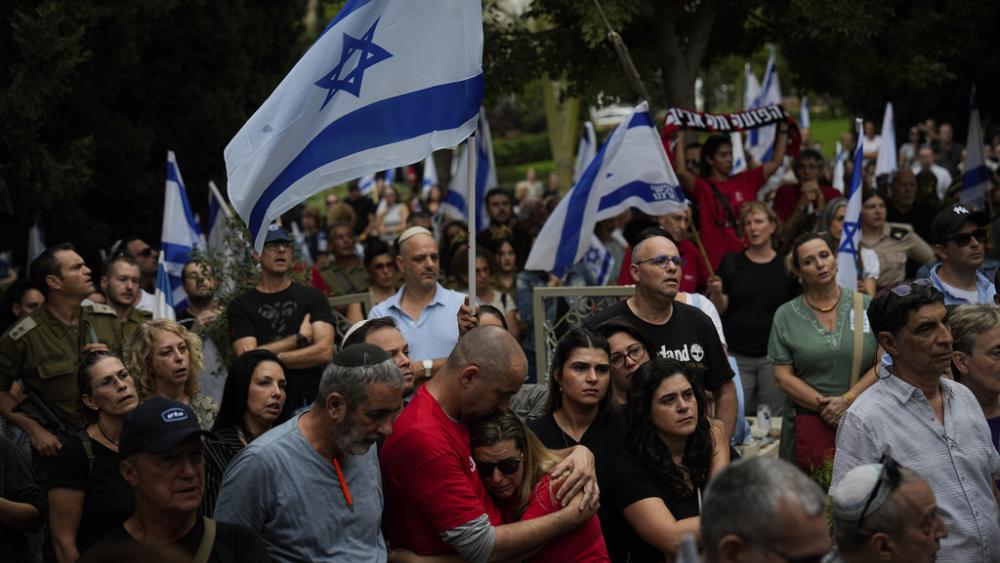 Mourners attend the funeral of Sgt. Roni Eshel in Kfar Saba, Israel, Sunday Nov. 12, 2023.  (AP Photo/Ariel Schalit)