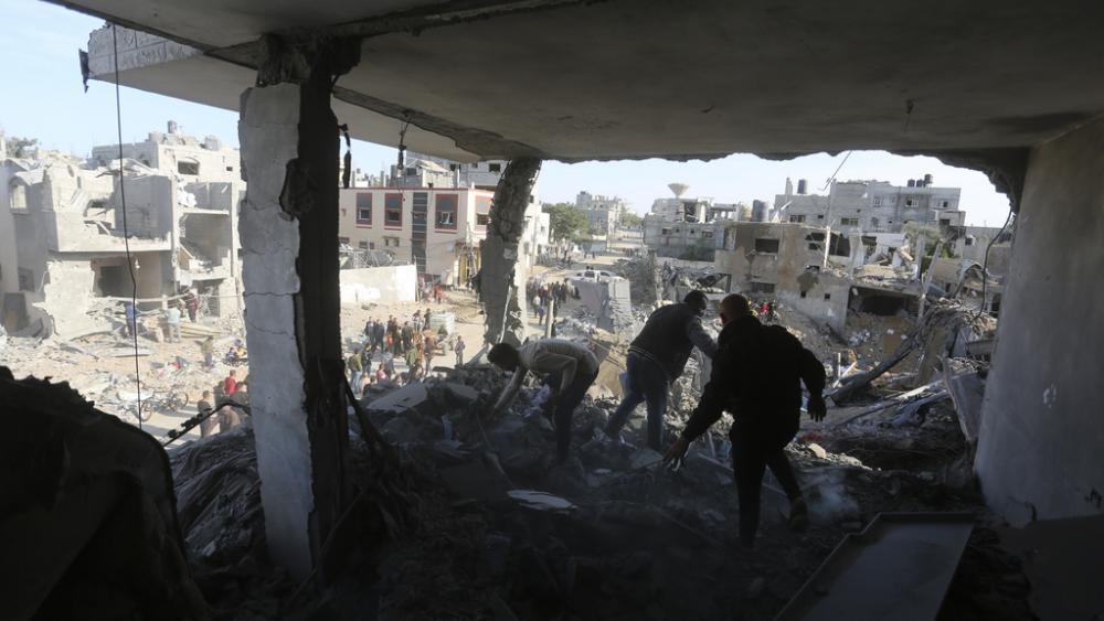Palestinians look at the destruction by the Israeli bombardment of the Gaza Strip in Rafah, Monday, Dec. 4, 2023. (AP Photo/Hatem Ali)