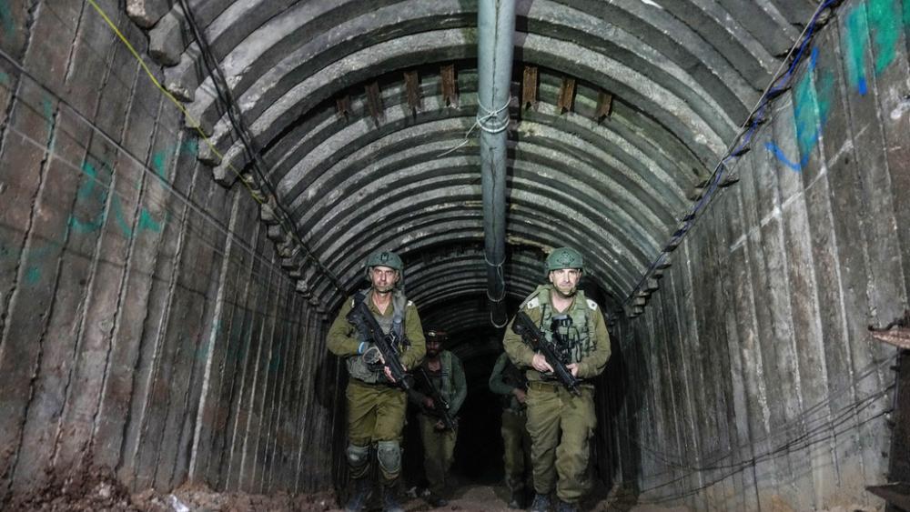 sraeli soldiers are seen in a massive tunnel that the military says Hamas militants used to attack the Erez crossing in the northern Gaza Strip, Friday, Dec. 15, 2023. (AP Photo/Ariel Schalit)