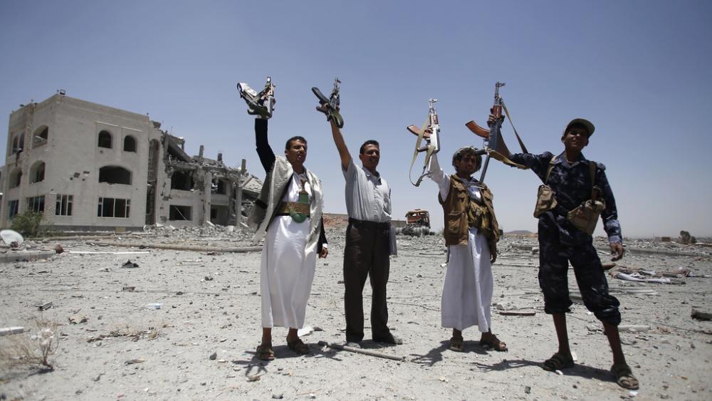 Shiite fighters, known as Houthis, hold up their weapons as they chant slogans in Sanaa, Yemen, April 28, 2015. (AP Photo/Hani Mohammed, File)