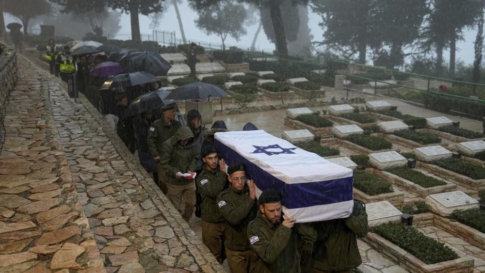 Israeli soldiers carry the flag-draped casket of reservist Elkana Vizel during his funeral at Mt. Herzl military cemetery in Jerusalem, Tuesday, Jan. 23, 2024. (AP Photo/Ohad Zwigenberg)