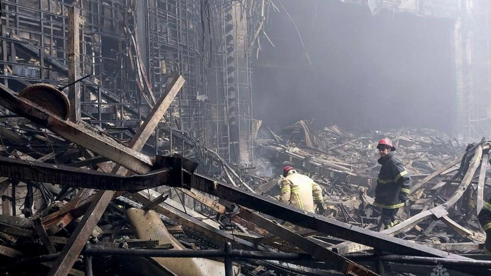 In this photo released by Russian Emergency Ministry Press Service on Saturday, March 23, 2024, firefighters work in the burned concert hall after an attack on the building of the Crocus City Hall, Moscow, Russia. (Russian Emergency Press Service via AP).