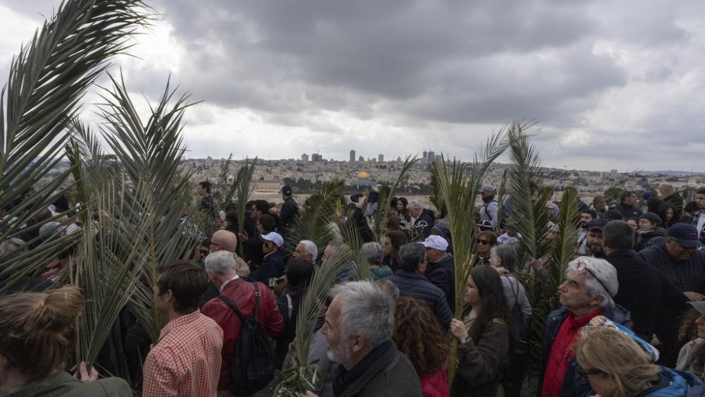 Christians walk in the Palm Sunday procession on the Mount of Olives in east Jerusalem, Sunday, March 24, 2024. (AP Photo/Ohad Zwigenberg)