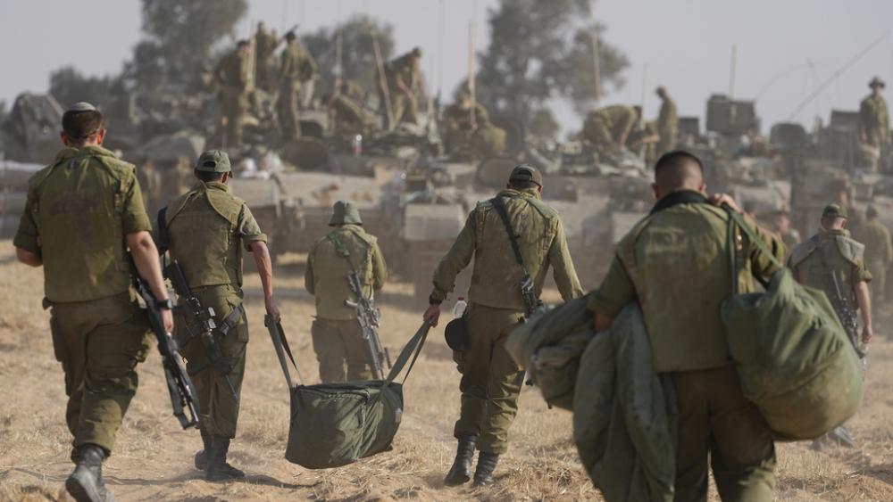Israeli soldiers are seen at a staging ground near the border with the Gaza Strip, in southern Israel, Tuesday, April 30, 2024. (AP Photo/Tsafrir Abayov)