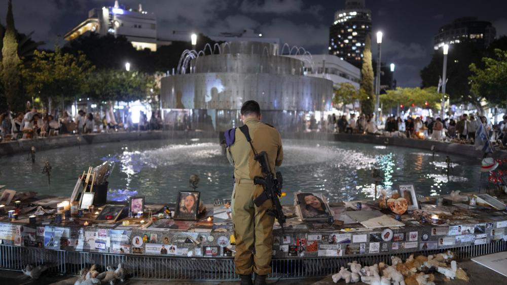 An Israeli soldier pays respect at a memorial for victims of the bloody Oct. 7, cross-border attack by Hamas on the eve of Israel&#039;s annual Memorial Day, in Tel Aviv, Israel, Sunday, May 12, 2024. (AP Photo/Oded Balilty)