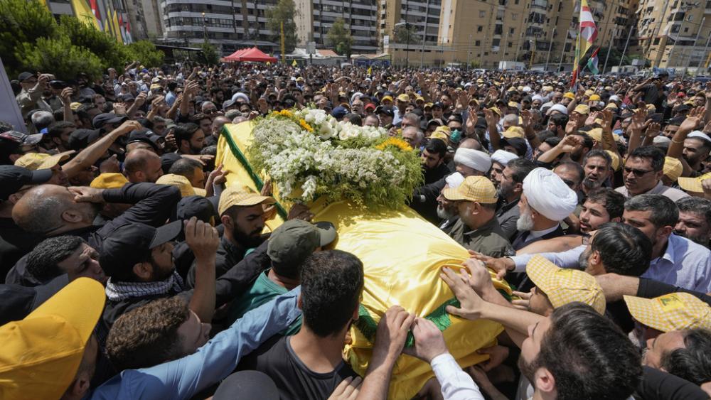 People carry the coffin of Hezbollah senior commander Taleb Sami Abdullah, 55, who was killed late Tuesday by an Israeli strike in south Lebanon, during his funeral procession, Wednesday, June 12, 2024. (AP Photo/Bilal Hussein)
