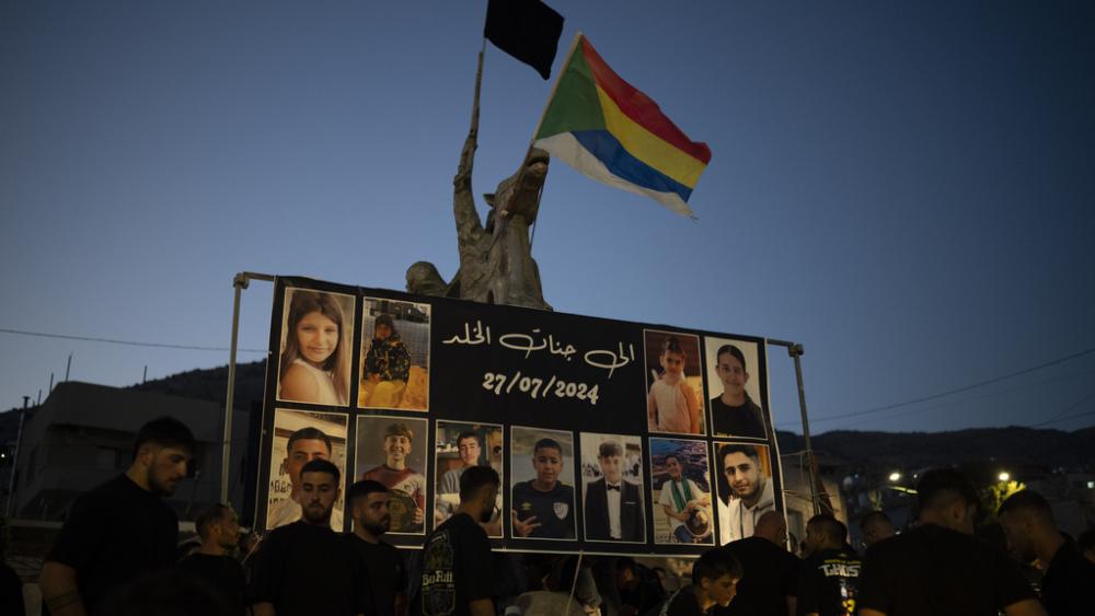 Photos of the children and teens killed in a rocket strike at a soccer field, are displayed at a roundabout as people light candles in their memories, at the village of Majdal Shams, in Israel&#039;s Golan Heights, Sunday, July 28, 2024. (AP Photo/Leo Correa)