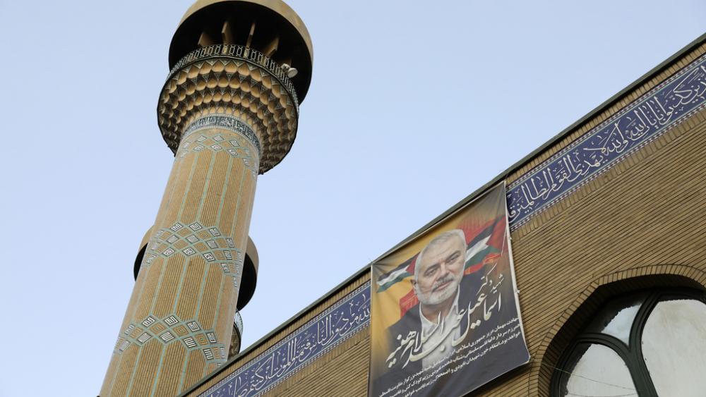 A poster of the late Hamas leader Ismail Haniyeh, who was killed in an assassination last week, hangs on a mosque building in downtown Tehran, Iran, Monday, Aug. 5, 2024. Iran has vowed to respond against Israel. (AP Photo/Vahid Salemi)