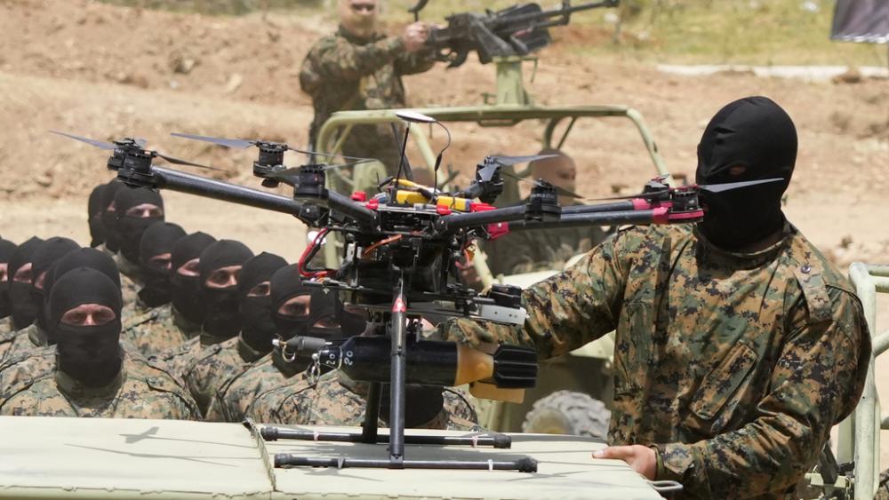  A Hezbollah fighter stands next to an armed drone during a training exercise in Aaramta village in the Jezzine District, southern Lebanon, on May 21, 2023. . (AP Photo/Hassan Ammar, File)