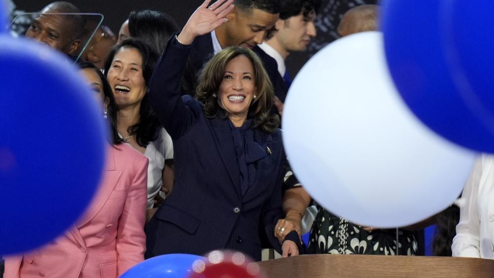 Democratic presidential nominee Vice President Kamala Harris waves surrounded by balloons at the Democratic National Convention Thursday, Aug. 22, 2024, in Chicago. (AP Photo/J. Scott Applewhite)