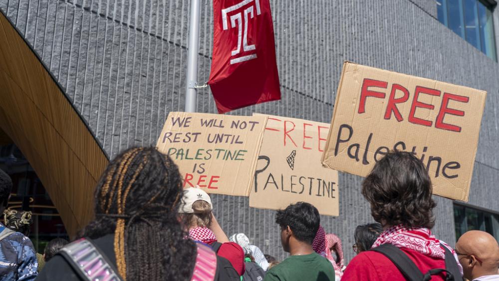 People hold up signs during a pro-Palestine rally and march on Temple University campus in Philadelphia, Aug. 29, 2024. (AP Photo/Chris Szagola)