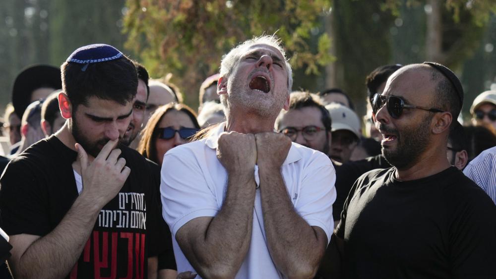 Yigal Sarusi, center, mourns during the funeral of his son, slain hostage Almog Sarusi, who was killed in Hamas captivity in the Gaza Strip, at a cemetery in Ra&#039;anana, Israel, Sunday, Sept. 1, 2024. (AP Photo/Ariel Schalit)