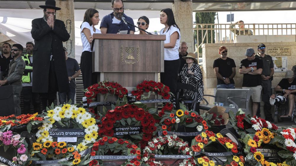 Jonathan Polin and Rachel Goldberg, parents, and the sisters of killed US-Israeli hostage Hersh Goldberg-Polin whose body was recovered with five other hostages in Gaza, speak during the funeral in Jerusalem, Sept. 2, 2024. (Gil Cohen-Magen Pool via AP)