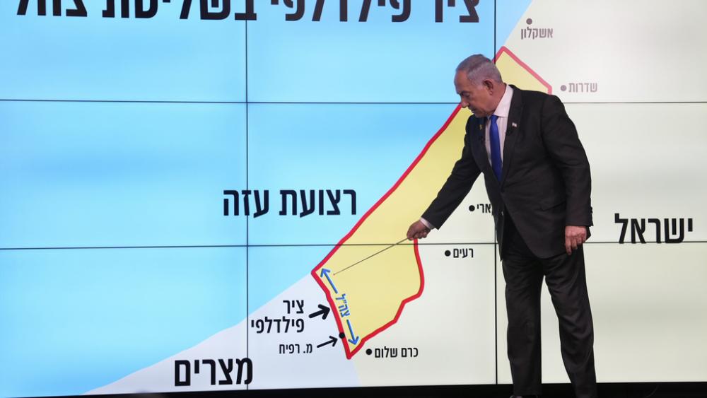 Israeli Prime Minister Benjamin Netanyahu stands before a map of the Gaza Strip, telling viewers that Israel must retain control over the &quot;Philadelphi corridor,&quot; in Jerusalem, Monday, Sept. 2, 2024. (AP Photo/Ohad Zwigenberg, Pool)