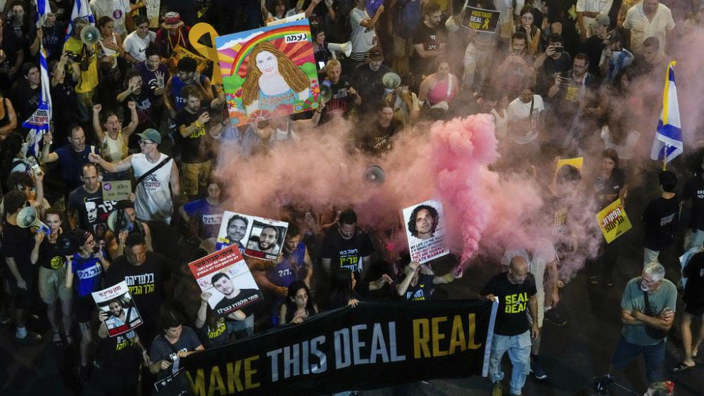 In this aerial image, people attend a rally demanding a cease-fire deal and the immediate release of hostages held by Hamas in the Gaza Strip in Tel Aviv, Israel on Wednesday, Sept. 4, 2024. (AP Photo/Ariel Schalit)