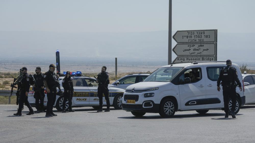 Israeli police stand guard near the site of a deadly shooting attack where Israeli officials say three people were shot and killed at the Allenby Bridge Crossing between the West Bank and Jordan, Sunday, Sept. 8, 2024. (AP Photo/Mahmoud Illean)