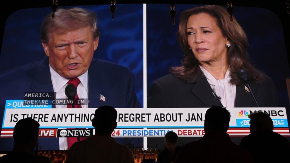 People watch the presidential debate between Former President Donald Trump and Vice President Kamala Harris, Tuesday, Sept. 10, 2024, at the Gipsy Las Vegas in Las Vegas. (AP Photo/John Locher)