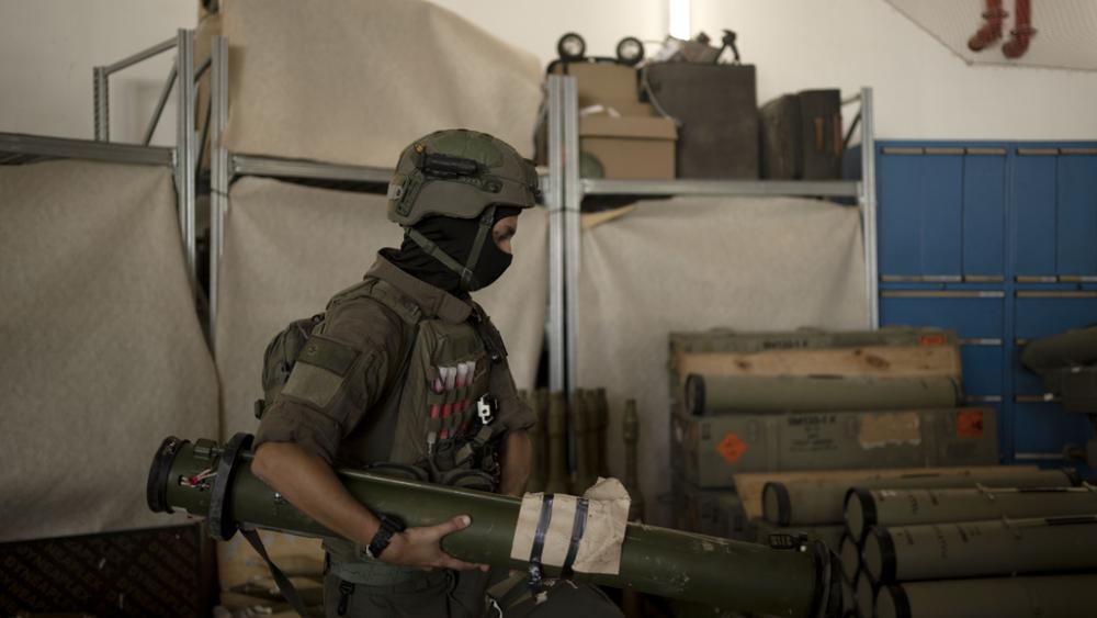 An Israeli soldier from an EOD (explosive ordnance disposal) unit moves a weapon used by Hezbollah seized during combat operations in Lebanon displayed during a government-organized media tour, Wednesday, Oct. 9, 2024. (AP Photo Maya Alleruzzo)