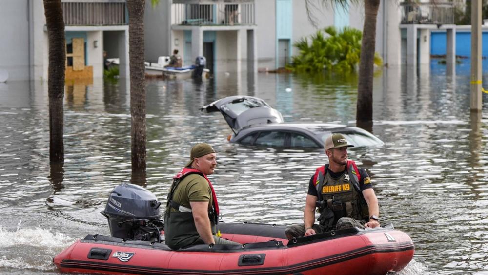 A water rescue boat moves in flood waters at an apartment complex in the aftermath of Hurricane Milton, Thursday, Oct. 10, 2024, in Clearwater, Fla. (AP Photo/Mike Stewart)