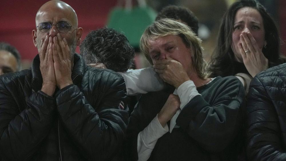 Friends and family of Ohad Ben Ami and Eli Sharabi, who were taken hostage on Oct.7, 2023 attack, watch broadcast of their release from Hamas in Gaza, at the Kibbutz Beeri, Israel, Feb. 8, 2025. (AP Photo/Maya Alleruzzo)