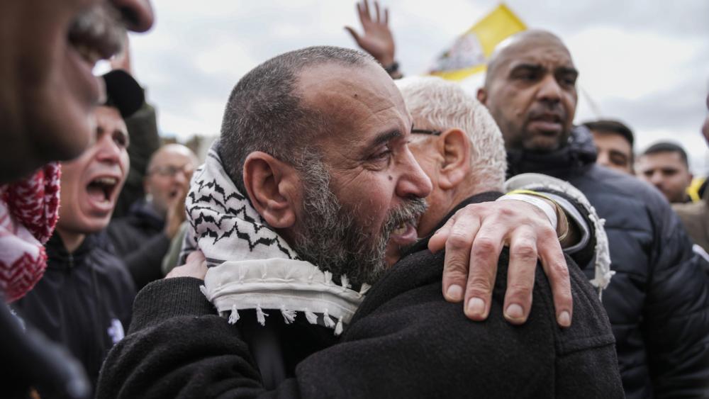 Palestinian prisoners are greeted as they exit a Red Cross bus after being released from Israeli prison following a ceasefire agreement between Israel and Hamas, in the West Bank city of Ramallah, Saturday Feb. 8, 2025. (AP Photo/Mahmoud Illean)