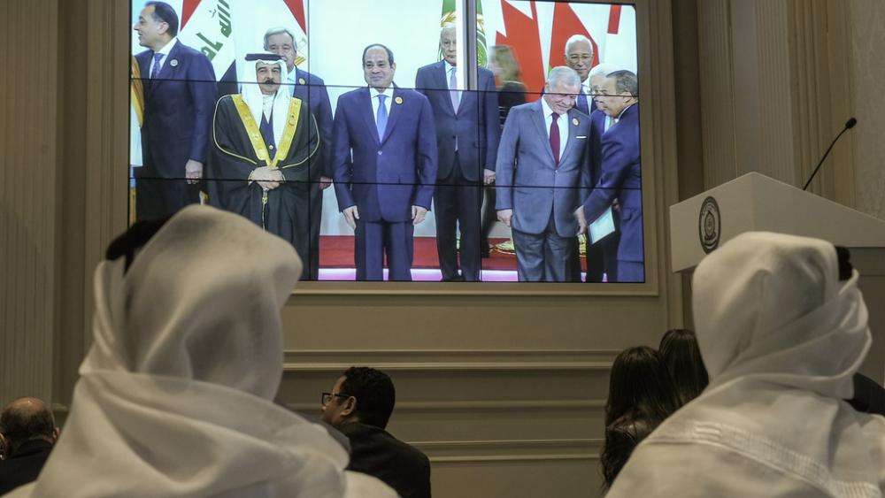 Journalists watch a screen displaying Egyptian President Abdel Fattah el-Sissi, center, with Arab Leaders, at the press center of the emergency Arab summit at Egypt&#039;s New Administrative Capital, near Cairo, Tuesday, March 4, 2025. (AP Photo/Amr Nabil)