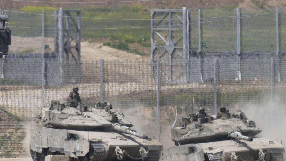 Israeli tank maneuver on the border with northern Gaza Strip as seen from southern Israel, Tuesday, March 18, 2025. (AP Photo/Ohad Zwigenberg)