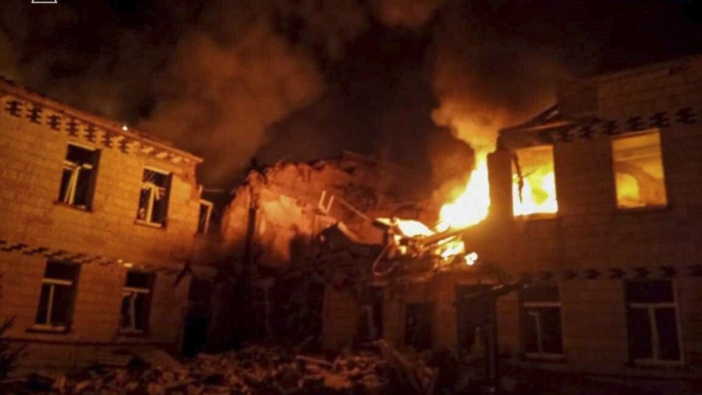 On Wednesday, March 19, 2025, flames of fire and smoke engulf a building after a Russian attack in Krasnopillia, Sumy region, Ukraine. (Ukrainian Emergency Service via AP)