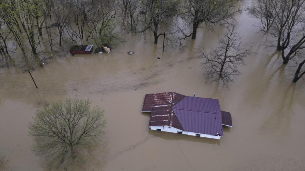 The rising waters of the Kentucky River flood and home in Monterey, Ky. Sunday, April 6, 2025. (AP Photo/Carolyn Kaster)