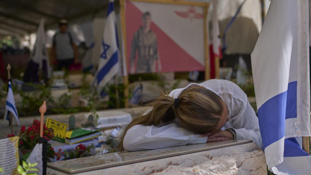 Girlfriend of Liel Haio, an Israeli soldier killed in Gaza, visits his grave on the eve of the Israel&#039;s Memorial Day, at the Mount Herzl military cemetery in Jerusalem, Tuesday, April 29, 2025. (AP Photo/Ohad Zwigenberg)