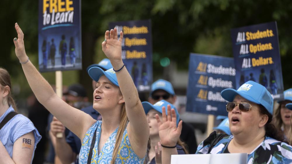 Pamela Smith of Sterling, VA, left, and Tammy-Kay Williams of Fountain Hills, AZ, right, support charter schools in rally at Supreme Court on April 30, 2025. (AP Photo/Mark Schiefelbein)