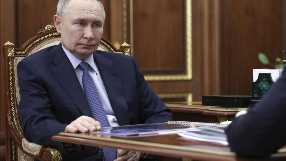 Russian President Vladimir Putin listens to Promsvyazbank CEO Pyotr Fradkov during their meeting at the Kremlin in Moscow, Russia, on Thursday, May 15, 2025. (Alexander Kryazhev, Sputnik, Kremlin Pool Photo via AP)