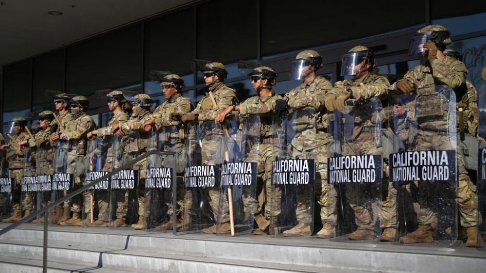 California National Guard stand in formation guarding the federal building in downtown Los Angeles on Tuesday, June 10, 2025. (AP Photo/Eric Thayer)